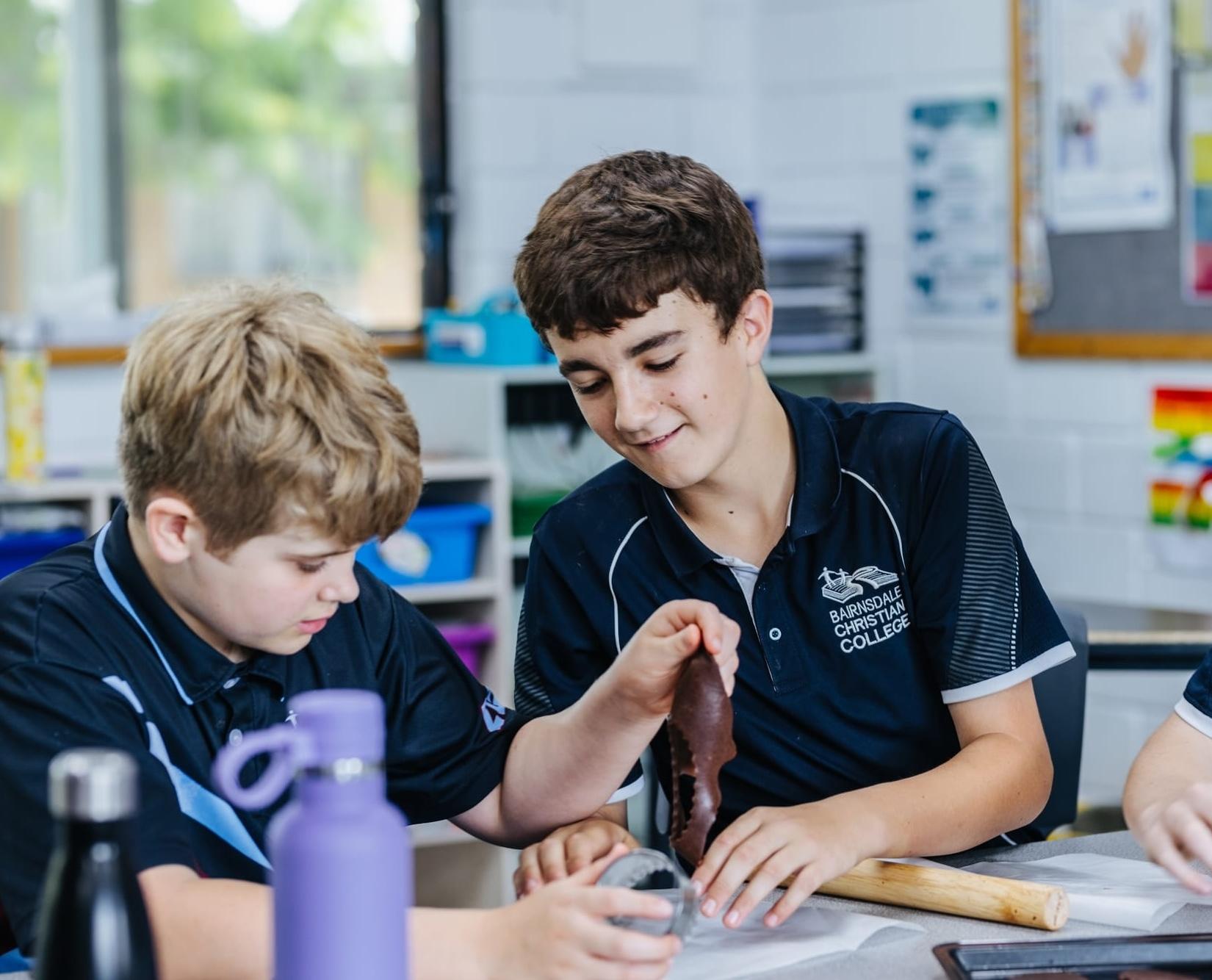 Senior school student captains sharing a moment of camaraderie outdoors at Bairnsdale Christian College.